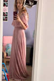 The dress is beautiful! I was worried with it being off the shoulder that it would slip down but no, it feels very secure! It's very long though. If I was a little taller it would be perfect. I'm planning on getting it hemmed. - Danielle L.