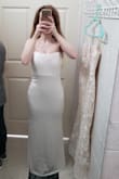 I was pleasantly surprised at how pretty this dress was! It's so much cuter in person. The dress ended up fitting like a glove. The only downside is that it's extremely long. In the photo, I'm standing on a stool so the dress wouldn't drag on the floor. I'm 5'1" and I'd say the dress is about 8 or so inches too long. I do plan on getting it hemmed though. I definitely recommend this dress!

*The side view photo is the dress when I first received it. The front view photo is after the dress was hemmed for my height. - Brittany G.