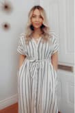 I love this dress! I wore it with nude heels and a purse to a cocktail event and it was perfect. I wore it to work (pic) it was perfect! Then I wore it for a casual date night to dinner with black boots and a black purse and it was perfect!!!! I'm obsessed with how classy it drapes, its an effortlessly chic look! - Ksenia L.