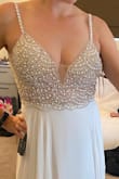 I had been eyeing this dress for a long time and was waiting for it to come back in stock.  Like many others, I had to postpone my big wedding, but I am still getting married with a mini-mony on the beach. This is the perfect flowy but still fancy dress at a great price!  The beading and jewels on the upper part of the dress are even more beautiful in person.  It is so sparkly! The dress comes with cups and padding that make the boobs look great and you don't need to wear a bra at all. I tried both an 8 and a 10. There is a slight difference in sizing, I chose the 10 because I have a large ribcage and the dress fit more comfortably.  I am tall, 5'9" and the dress is still long on me, so it's definitely good for tall girls or will need to be hemmed. I HIGHLY recommend if you can get it before it's out of stock again. - Carlina V.