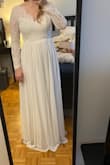 This dress was perfect! I had to downsize my wedding to immediate family only and didn't get to go wedding dress shopping at a bridal shop before COVID hit. I ordered a different dress from Lulus originally but panic bought this one 3 weeks before my wedding after I dropped off the original dress to be hemmed by a tailor I didn't trust and I'm very happy with that decision. 

There were a couple things I didn't love. The ribbon in middle looked kind of cheap to me so I added a thin pearl belt to cover it up. I also noticed in pictures from the wedding that the dress kind of slipped off my shoulder a bit.

I did have to get about an inch hemmed but it otherwise fit well. One picture is before hem and no belt and the other is after hem with the belt. - Courtney T.