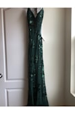 Fits like a glove. Beautiful dress all around. Material on the inside a little scratchy. Never been worn. - Sara G.