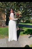 This was a beautiful dress for my mini wedding ceremony. I bought this last minute but ended up needing to get alterations done which ended up costing me the exact same amount as the dress did.
Arm length needed to get brought up about 2 inches as it went past my finger tips.
Waist got brought in 1.5-2in
Length for brought up 3.5 in.
This may be a good dress option for taller ladies but if you are my height or shorter just know you may need some alterations or EXTRA high heels. I wore 2 in heels and it was still a little long!
Oh P.S. get your self some fashion tape to hold the back scallops down! - Constance