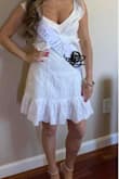 Got this dress for our quarantine bridal shower. It was a little big on me because I am short so I washed it so it would shrink in the dryer. It was loose fitting on the waist but tighter on the natural waist. I am really skinny and in some photos it made it look like I had a stomach which you can see in the photos. Also you have to wear either no bra for the open back or a sticky bra which is what I did. I love this dress overall and will wear it many more times. - Melissa D.