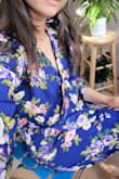 I love the vibrant color of this dress! They quickly became my favorite. I wear them at least once a week. As you can see on promo pictures they have a little bit loose fit so if you need them to be more fitted, probably size down. They are stretchy in waist and very forgiving. I even like the slightly puffy shoulders! What you need to be aware is the cleavage. I didn't feel comfortable wearing the dress unless I fixed it with a pair of sew on snaps. It was a very easy fix. Now I do not need to be worry that my breast will fall out when I bent over or that the dress will show bra when moving. I was very lucky to get this dress on final sale for a better price. Would totally buy them again! - Michaela M.