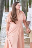 It photographed beautifully. I did have some snaps added. The wrap left me feeling a bit too exposed, made it difficult with the bust. I also had the top shortened a bit. I think a medium would have been a better fit for me. Absolutely loved the dress and color. - Hailey L.