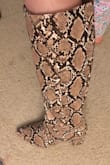 I adore the boots! I especially love that unlike other snake boots I've seen, these don't have a visible zipper! Since the toes part is triangular in shape my regular size (8) fit tight, but I sized up to a size 9 and they fit perfectly! The heel isn't too high, so walking in them does not hurt after a while. They reach the perfect height! My calves are slightly bigger than others and these do not fit tight around them, I can wear them with pants and still have some room. - Paola L.
