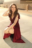 I wore this dress to a wedding and a photo shoot and loved it. The tie allows you to fit to your waist perfectly, and the slit is sexy while the fit is elegant. Only thing that would make it better if it was fully lined instead of lined to high-mid thigh! - Alexandra B.