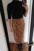 I was unsure about this when I purchased it, but I ended up really liking it. It is a little confusing to put on at first because it's a wrap skirt. The material is more forgiving around the tummy area on me than satin skirts and pleated skirts, so I was happy about this one. - Melissa H.