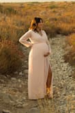 I bought this dress for my maternity photos. I was 33 weeks when I wore it, and the dress fit a little big on me. However, I ordered the blue color and that actually fit more snug, so that was weird. 

The chest cut didn't fit me too well, and I'm a D cup. The neckline didn't sit flat against me, so that was annoying. I'm not sure it really flattered my waist too much (but I'm preggo so that could be why.)

Overall, I liked it, and even with my pregnancy weight, a small fit a little big on me. Can't wait to try to wear it again after I have my baby and lose the weight. - Angie D.
