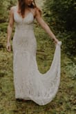 The dress was form-fitting, but still easy to move in for an outdoor elopement shoot.  It was much too long for me so I had it hemmed and also had thin straps swapped in for the adjustable one's.  It's fully lined and the lace looks great up close.  You do have to be careful not to snag the lace, but it held up really well and actually held up to washing.  This dress was a great value and I didn't have to feel guilty about getting it a little dirty. - Lindsay L.
