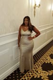 The dress is a must buy! The material is stretchy, especially around the hips. Straps are adjustable. I received so many compliments all night. I will buy again in a different color. - Edlyn L.