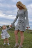 I have received many compliments on this dress. The material is so soft and flattering. Fits true to size with room. Not tight but not too loose. I have long arms and the sleeves are a perfect length. - Brenda G.