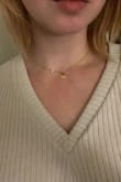 The pearl does move along the chain as I had suspected. The length is not adjustable but it's a nice medium length. Very cute purchase! - Katie B.