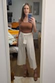 I love these pants because you can easily wear them in the summer with a pair of sandals, or in the fall/winter with a pair of boots. I had to exchange them for a size up because the first size I ordered were a little snug in the waist. Again, I have to remember these are models in the pictures who are probably pretty tall. I'm 5'4", so they were too long on me. I took them to a tailor and had them shortened a bit, and now they are perfect. I couldn't find the tank top in the picture (I really loved the rust orange color with the pants), so I had to go on Amazon and find something similar. In the fall/winter, I will wear this with a short sweater. - Pauline H.