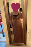 So... in my photo, it's smaller on me. If I wanted the ideal fit for my body now I should've bought an XL, but I'm currently still losing weight and by the time I get to date I'll need to wear it by it'll fit the way it should. It could still work as is but would need a few tweaks in the chest area. I also quickly put it on by myself.. which made it a little more challenging to get the perfect fit without having to take it on and off over and over again. - Megan H.
