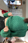 I love love love this sweater. I wrote it runs big because I ordered up. Usually I am a small, went with medium for the extra room. It's slightly higher in the front, but covers everything. Looks super cute with jeans. - Molly P.