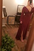very elegant, and flattering with a slit to mid thigh. the tie in the back helps with placement. sizing is like lulus other dresses, I'm usually a strong M but tend to have to size down to small which this is. it's a bit snug and I wouldn't wear on a bloated day:). the zipper feels cheap and like it is going to snap. will send back because of this. would be great for professional pics, weddings, etc - Jessica M.