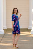 This wrap dress is such a pretty blue and is very easy to take on and off!! It's flowy and comfortable. My only struggle was finding a bra to wear with it. The V Neck is lower than I thought, but it's easy to use a safety pin to make it higher if wanted. Very comfortable, not too short, and perfect for any occasion! - Brielle A.