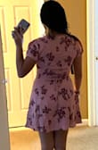 I like this dress' fabric. I like the button detail. It has a zipper along the side. This one has a low cut in the front, maybe wearing a bra it could be difficult (depending on the bra type). It is very flattering as you can adjust the dress and make it hug you however you like to accentuate your figure. - Astrid A.