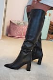 Been looking for knee high boot since last fall. Glad I waited because this boot rivals higher priced brands. Love the fit, style. Looks great with jeans, leggings skirts or dresses. The circumference is more than sufficient for my calves (mine 15.5" round). I'm 5'10 and the boots hit at top of my knee. I push the boots below my knee. Can feel awkward at bend in knees but not a deal-breaker for me. I would not recommend this boot for petite person or smaller calf. I'm definitely not disappointed and would recommend to anyone who's been searching high and low for a tall boot. Plus it's wide calf friendly without being wide calf. - Maria T.