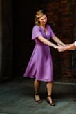 This dress is gorgeous. I needed to hem it a bit to get the length and sleeves exactly where I wanted since this was for engagement photos, but still love it either way. I did not find it to be as low cut as some other reviews. Very flattering style. - Kelli D.