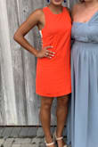 Loved this dress so much! It is form fitting without being too tight or "body-con". The color is a bright orange-red, perfect for the summer wedding I wore it to. I received so many compliments on the dress. My rib cage is a little big so I teeter between a small and medium, but the small worked great. I wore pasties instead of a bra since the back was open. - Claudia H.
