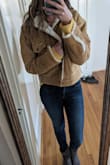 This jacket is so incredibly warm and cozy. I'm usually a small but I ordered a medium cause I like my jackets a little bigger. The arms are weirdly short but when I leave the sleeves unrolled it's fine. I also wish it had pockets. Still SUCH a comfortable jacket. - Kristen S.