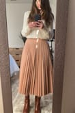 Beautiful skirt, easy to dress up or down. I got a size S but felt like I should have ordered an XS (it wanted it to sit at the high waist but it won't unless I tuck in a thick sweater like the one in the picture). I loved it anyway. - Beatriz V.