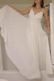 Pretty cream color with a really flowy skirt. The over layer has a split in the middle, which makes it even easier to move it around. Good quality, was a smidge large but would fit better if I had a larger chest or bigger bra. Nice bodice. - Angela M.