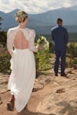 It was a beautiful dress for our mountain elopement but I was disappointed in how quickly it fell apart. The material on the skirt is strong and heavy but unfortunately the lace did not survive the morning (and this wasn't a hiking destination, it was easily accessible so the dress did not have to withstand the rigors of mountaineering or anything like that). Luckily the price point is excellent for a wedding dress (most people do only wear it once) and my sister cut the lace and skirt into a beautiful dream-catcher afterwards so I am still happy with the purchase, just keep it in mind if you're thinking of ordering it that it may only survive one wearing. It is very long and most likely will need adjustment. I am 5'7 so not too short and the small needed at least a 2in hemming for what you see in the photo. - Megan G.