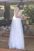 I was so happy when I found this dress. I wanted something that looked like a wedding dress, but at an affordable price point and this was it! 
I was happy that I read the other reviews because I originally ordered a medium. I then also ordered a small, which was a perfect fit. Lulus customer service was great and got both dresses to me quickly.
The one flaw is that the lower part of the dress isn't as heavily lined as I originally thought and is definitely see through. I got married in November outside so all I needed was ivory fleece lined leggings to solve the problem.
So happy with this dress! - Carrie N.