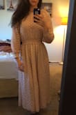 I love how the slip is built in on the inside, that way everything stays were it is supposed to. More of a pink lavender color than tan, but I really like the look of it. The white flowers make the color pop. I like that it's a pull over dress; don't need to worry about zipping yourself up. - Kendra T.