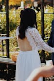 I adore this dress. I honestly don't think I could have found a dress I loved more even if I paid 1,000$. The lace is delicate and detailed and the scalloped edges on the sleeves were a dream. The front is lovely and the back makes for a fun surprise for the husband! :) I am so impressed with the quality of this dress for the price and would definitely recommend Lulus to anyone who is looking for an affordable wedding dress!

It does run large so have the expectation to get it altered. My tailor took in the sleeves, chest, and waist, and hemmed the skirt in three days. The chest area was still a little bit loose but I'm extremely flat chested and I'm sure if you gave someone enough time they could make it more snug for you. I do think the extra small would probably have been too small for me at the waist so I'm happy I went with a small. - Vanessa R.