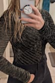 This bodysuit is SO cute! I am 5'9," and it is long enough for my torso; I have difficulty finding any bodysuit/jumper that works. The material is comfortable and has a decent stretch to it. I was also pleased to see that the sleeves are long enough for me because I have pretty long arms. It's fitted for my body type, but I think even if I were to lose 10lbs, it would still fit snuggly because of the material. Also, I thought it would be see-through because of the mess; it is not! Which is fantastic because I am not that bold! My only complaint is the snaps are a bit bulky on the bottom, but if you were underwear with it, you don't feel it. It's also not a full coverage bottom, so be aware that it's more thong style. I would recommend it! - Ashley H.