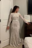 I ordered the size small and it fit me too tight to the body. I probably should have ordered a Medium. However, I quickly learned that an all lace dress was not a good fit for me so I choose a different Lulus wedding dress. I'm sure this dress will look great on someone else. I have a pear shaped body. My hips and thighs were too big for a size small. - Diana C.