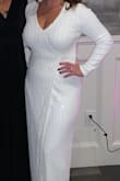 I purchased this dress for my rehearsal dinner for my winter wedding. I am bigger busted so it needed to be altered- I took it to have the open v-neck sides sewn more together because my boobs were completely popping out. One my tailor sewed them together the dress was perfect. It was the perfect sleeve length on me along with length with 3.5" heels. I got so many compliments on this dress. It was disappoint. - Mairin B.