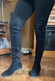 These boots fit true to size. I purchased a 7 and still have room to move my toes! I wore these boots with leggings and they did not slide down once. The material on the back of the boot is different from the front. I didn't think I liked the different material but once I put them on I loved them. They are sleek looking, stretchy and fitting. Love these boots. - Alyssa A.