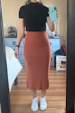 Does run large. Usually would order a medium, but a small fit perfectly. It's sooo cozy and comfy, and I love the stretchy ribbed sweater fabric. Pairs great with crop tops and bodysuits, tights or no tights, and boots or sneakers. Got it in both black and orange and I'm particularly smitten with the creamy orange. It's a lighter color than depicted in the photo, but still love it. - Joy M.