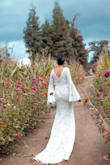 I ordered this dress online off of whim because it looked really nice, was very affordable and if I didn't like it- I could easily return it back. As I tried on the dress, it was absolutely perfect and I realized the style matched perfectly for my outdoor, whimsical, November wedding.
I did have a few alterations to have my dress fit like a glove: tightened the shoulder areas by about 1.5 inches, trimmed the bottom-front by 2-3 inches (my heels were only 2.5 inches tall), and added a wrist loop to hold the train up when I danced around all night at reception!
Overall the dress+alterations totaled about $250 which is still a real bargain for a wedding dress!! - Ana R.