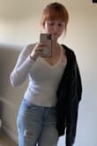 Wow doesn't even really show a black bra through! I hate see through shirts and having to layer so this is perfect. So soft. Stops at the perfect hip length with a flattering but not too revealing v neck. Doesn't shrink in the wash. - Katie B.