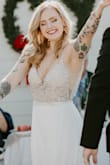 I wore this dress for my small outdoor covid wedding and it is such a stunner! The beading detail on the bodice is so beautiful. It also has built in bra cups which was really nice since my boobs aren't the biggest so I didn't need any additional bra/tape. I got so many compliments on this dress and I felt so beautiful. The pictures do not do it justice! I highly recommend this dress!! - Shaina W.