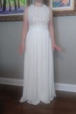 This dress fit perfectly and was very comfortable. It was slightly too long. If I had decided to keep it, I would have gotten it hemmed. I really liked it but since I bought many dresses I needed it narrow them down. I decided to eliminate this one cause I thought it made me look wide from the front pictures. Loved how the back looked! - Kimberly H.