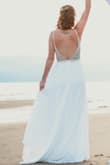 I had originally bought a different dress in a boutique but my mind kept straying back to this dress. When we changed our venue to the beach, I decided to order it. I'm SO glad i did! It is absolutely beautiful and well well worth the price! I ordered a 2 and it fit a little big on the top, I wish I would have ordered a 0, but it photographed fine. The back is gorgeous and the bead detail is just beautiful. Absolutely love this dress! If you're contemplating it, buy it!!!! - Lacey D.
