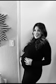 Wore this for the holidays very comfortable and paired well with my baby boy bump. Stretchy and wore my maternity spanx underneath. I'm not sure how many inches my belly is but I'm 5'3" and the dress went a little above my knee. - Giovanna W.