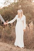 I bought this dress for engagement pictures and it photographs beautifully. I love the ivory color and how it's a true wrap dress. Also the buttons on the sleeves were beautiful. The only downside is that it gapes in the chest area, but this was nothing dress tape couldn't fix. - Maddie B.