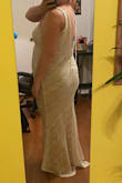 This dress is stunning. The fabric looked like high quality. It runs a little short for me. It it very form fitting, and does not look good on me unfortunately. Uploaded a picture in case someone has my body shape. - Marte V.