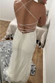 I ordered this dress as a wedding dress option. Dress has beautiful floral embroidery. Low back with hidden zipper/clasp. The Cris-cross ties are like a satin material. I have a small chest/cup size and the top of the dress still fits good, not a lot of gaps. There is a train to this dress. Very elegant feel. There is a sheer piece that covers the deep V in the front of the dress. Material is comfy to wear and you can move around in the dress just fine. Only downfall, the glitter that is on the outside layer of the dress. The dress is two layers.
I have an athletic build, wider hips and a booty. 135-140 Lbs and the size 4 fit perfect. - Tabitha E.
