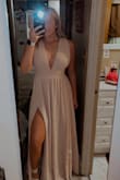 It is a little tight, but still fits great. I struggle to get the zipper all the way up due to the thickness of the fabric around the belted area just takes another person helping me to zip it up. Very beautiful dress! Is a little long even in heels - Nicole B.