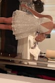 I look too much like a pixie, but otherwise it is pretty. No stretch for zipper FYI. The top would have been tighter had I adjusted it. - Megan H.